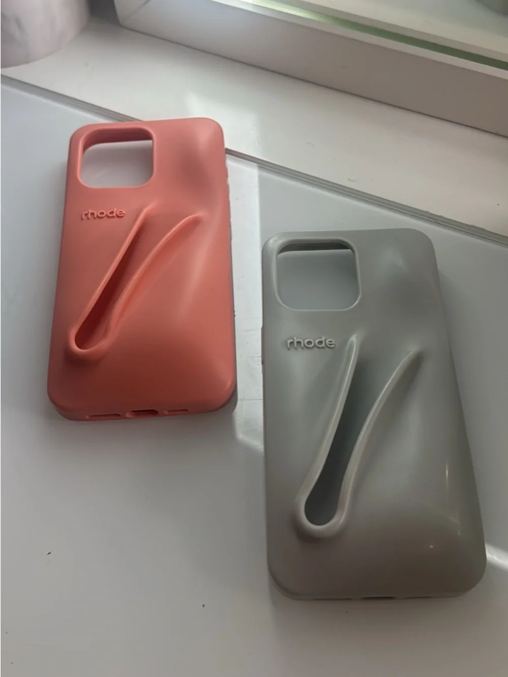 RHODE Silicone Phone Cases with Built-In Grip in Coral and Light Gray